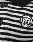 Closeup detail of embroidered mascot medallion patch on striped diaper shirt.