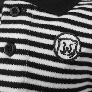 Closeup detail of embroidered mascot medallion patch on striped diaper shirt.