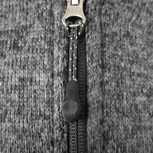 Closeup of textured rubberized zipper pull.