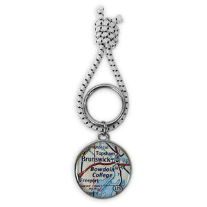 Key ring with map of Midcoast Maine featuring Bowdoin College under a cabochon. 