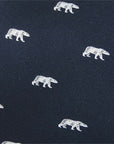 Closeup of woven polar bear design on navy blue necktie.