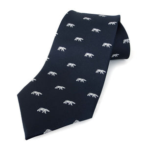 Rolled up navy blue necktie with white all-over woven imprint of polar bears in profile.