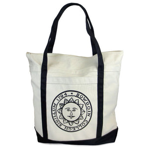 Natural canvas tote with black handles and bottom. Bowdoin sun seal imprint on front pocket.