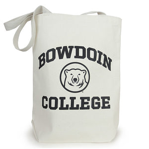 A natural-colored canvas tote bag with black BOWDOIN COLLEGE and polar bear medallion imprint. BOWDOIN is arched over the bear head medallion, and COLLEGE is in a straight line underneath the medallion.