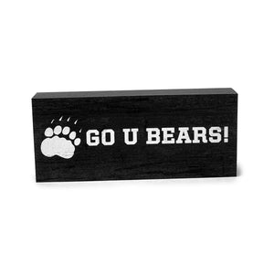 Grey wooden block with white imprint of pawprint and GO U BEARS!