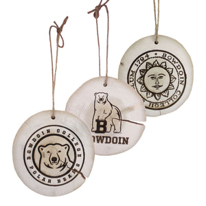 Three driftwood ornaments with center ice medallion, Bowdoin mascot, and Bowdoin seal.