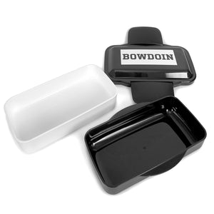 Deconstructed bento box showing white layer, black layer, and black lid with white rectangle with black BOWDOIN imprint.