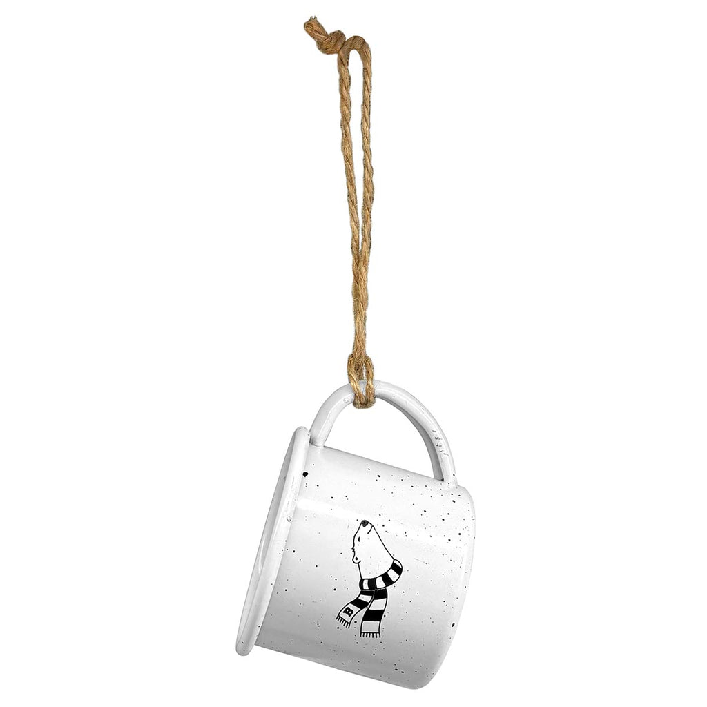 Miniature white enamel campfire mug with black speckles and imprint of a cartoon polar bear's head and neck with a black and white striped scarf flowing behind. The mug is hung by a loop of natural twine.