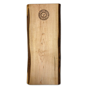 Wooden breadboard with laser engraved Bowdoin College seal at top end.