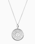 Small round silver pendant necklace with Bowdoin sun seal engraving, surrounded by sunburst edging.