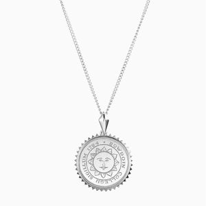 Small round silver pendant necklace with Bowdoin sun seal engraving, surrounded by sunburst edging.