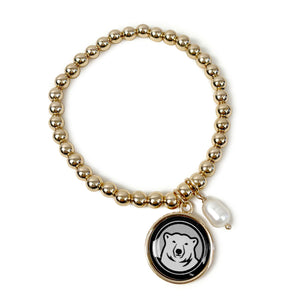 Round bracelet of gold-tone beads with dangling oval faux pearl pendant and separate polar bear mascot medallion pendant.