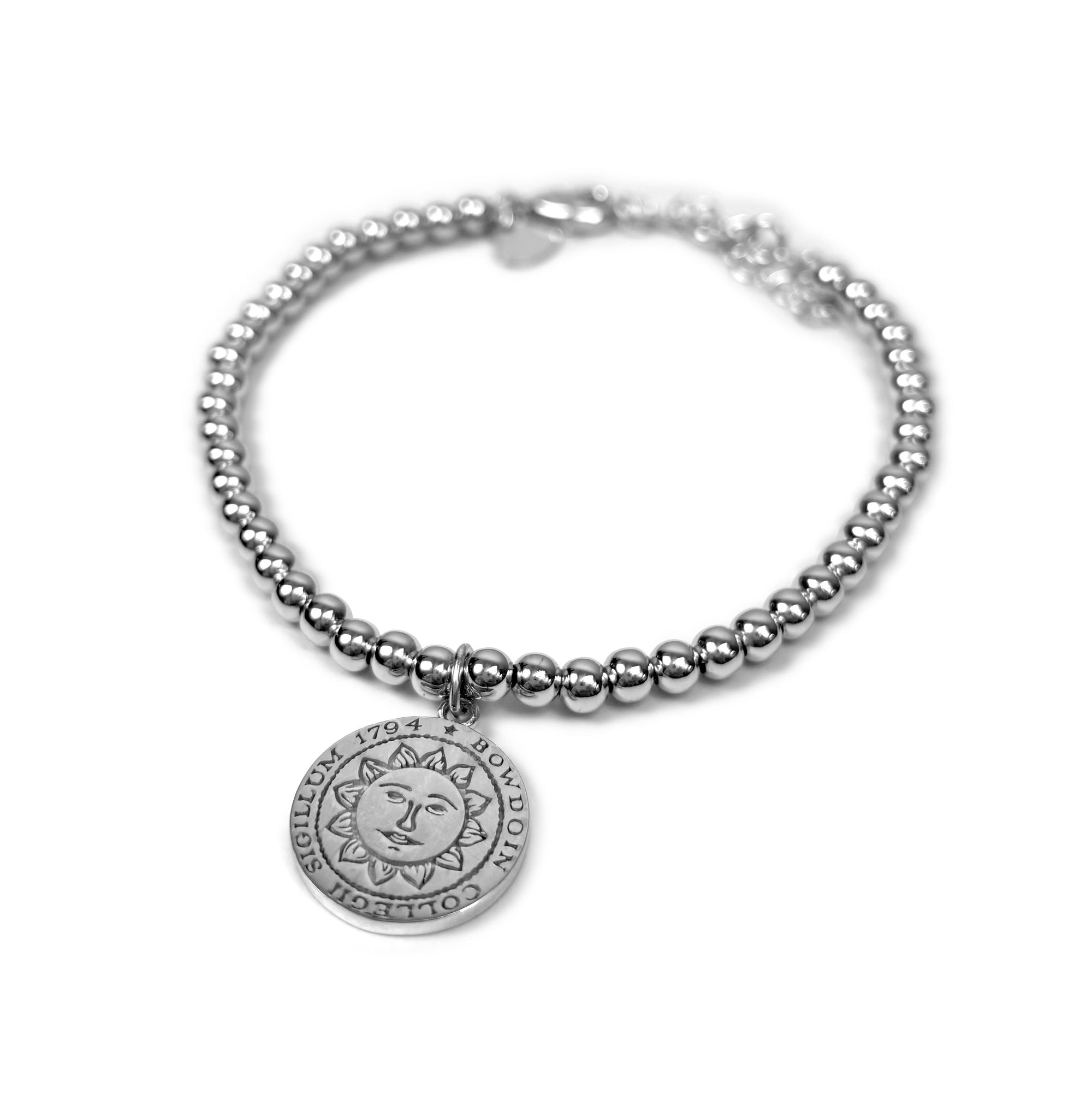 Silver beaded bracelet with Bowdoin College seal pendant on a white background