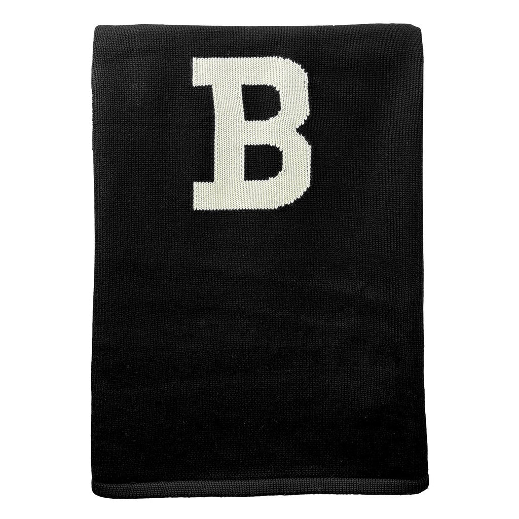 Folded black baby blanket showing a large ivory B in the center of the blanket.