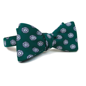 Deep green silk bow tie with all-over print of Bowdoin College seal.