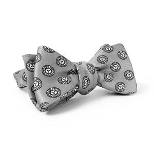 Light grey silk bow tie with all-over print of Bowdoin College seal.