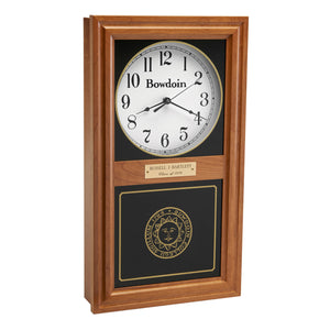 Autumn finish wall clock with clock face in upper inset in white with a Bowdoin wordmark and Arabic numerals, and a Bowdoin College seal in gold on the lower glass. Optional brass engraved plaque is shown on midrail.
