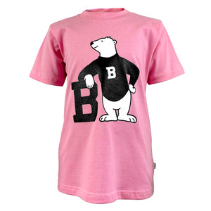 Pink children's T-shirt with large chest imprint of a cartoon polar bear wearing a black sweater and leaning on a black letter B.