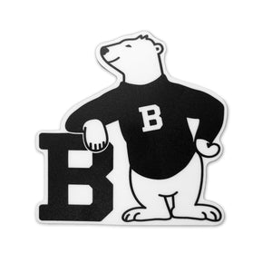 Black and white sticker with cartoon bear wearing a black sweater and leaning on a large black B.