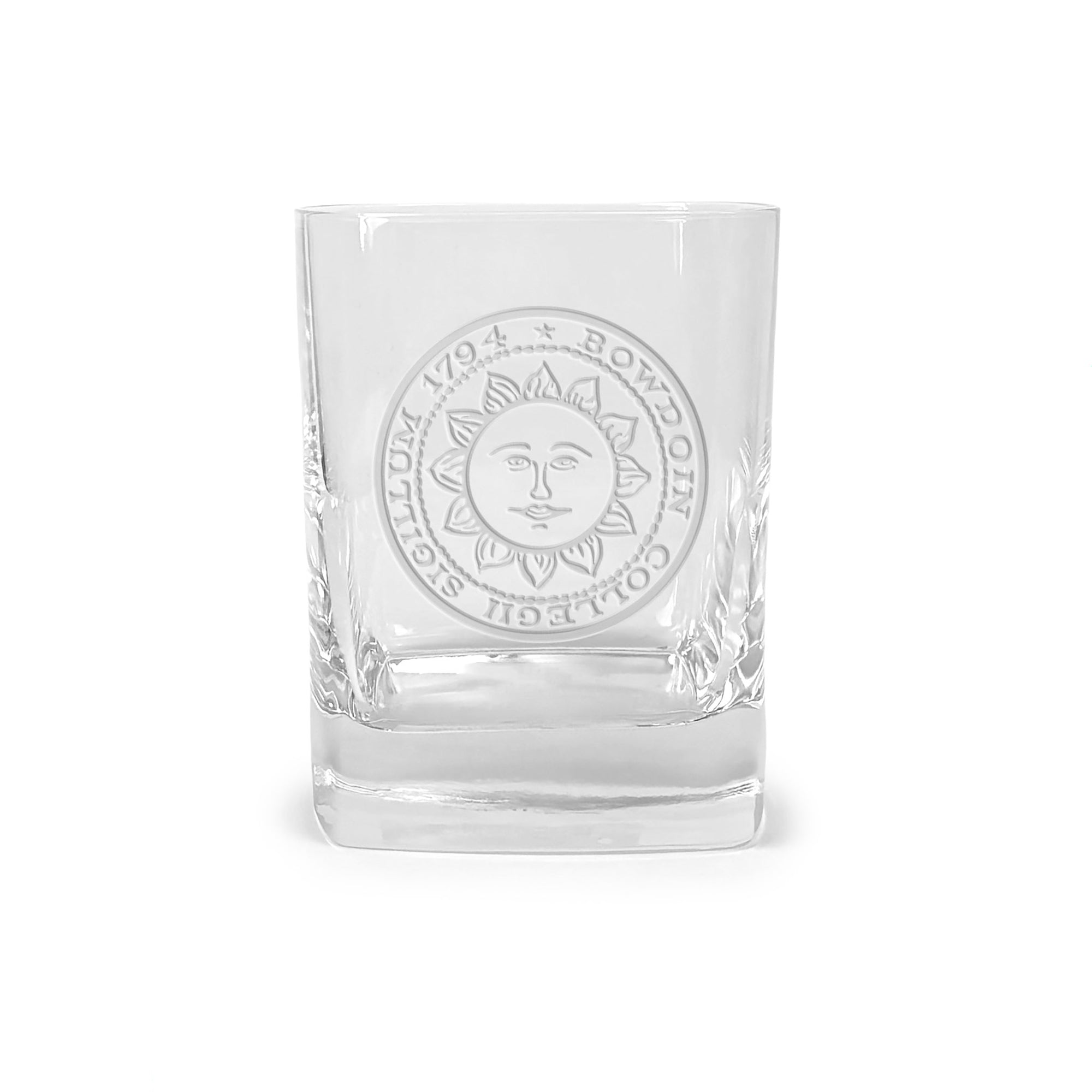 Clear glass tumbler with engraved Bowdoin College seal on a white background
