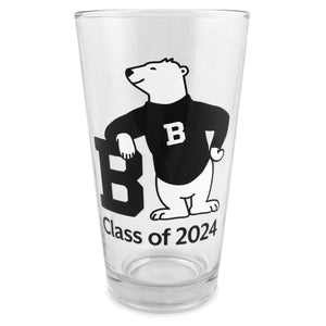 Clear pint glass with imprint of cartoon polar bear wearing a black sweater with a white B on the chest, leaning on a large letter B, over black text CLASS OF 2024.