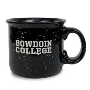 Black mug with white speckles and curved lip. Etched BOWDOIN over COLLEGE decoration.