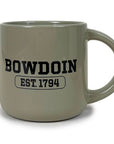 Warm grey mug with large round handle and black BOWDOIN over a cartouche containing  EST.1794 in black.