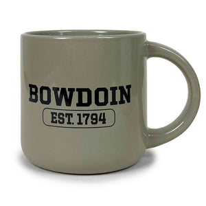 Warm grey mug with large round handle and black BOWDOIN over a cartouche containing  EST.1794 in black.