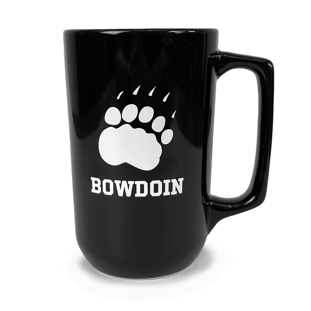 Tall and narrow black mug with long rectangular handle and white imprint of paw over BOWDOIN in athletic logotype.