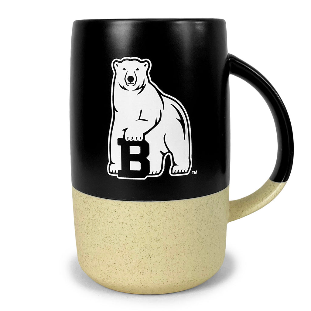 Tall barrel shaped mug with round handle. Top 2/3 are matte black with a white polar bear mascot imprint, the bottom 1/3 is speckled natural beige.