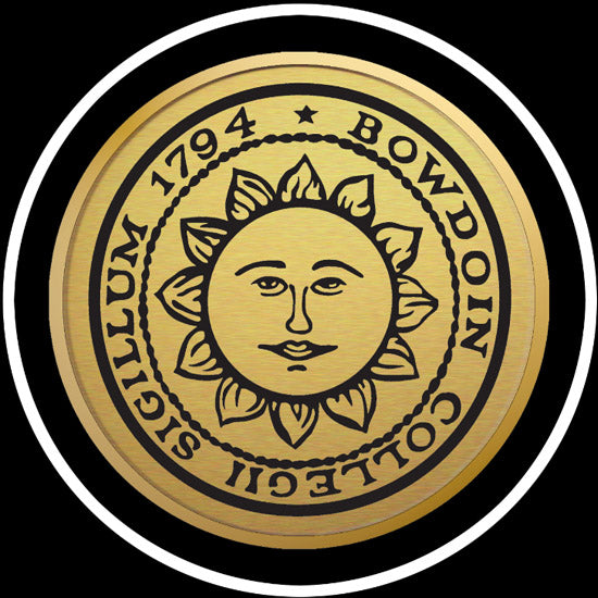 Closeup of engraved Bowdoin sun seal medallion in gold