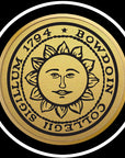 Closeup of engraved Bowdoin sun seal medallion in gold
