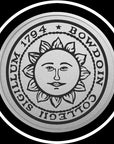 Closeup of engraved Bowdoin sun seal medallion in silver