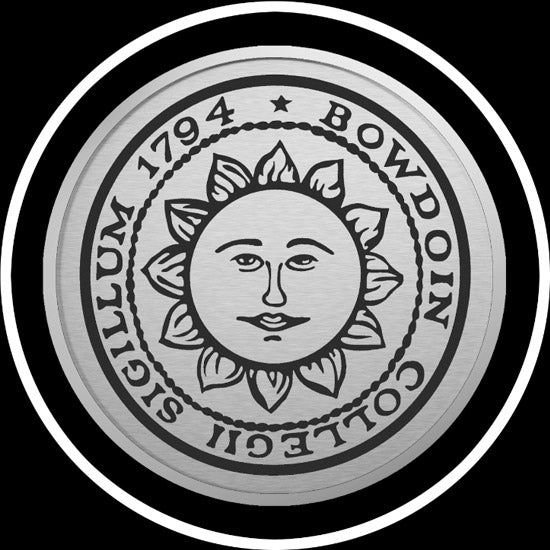 Closeup of silver sun seal medallion.