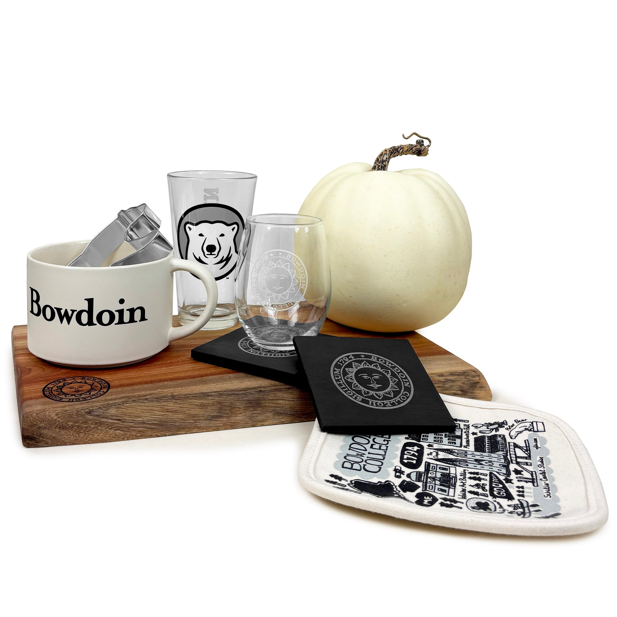 Bowdoin branded items including a mug, glass, and pumpkin on a white background