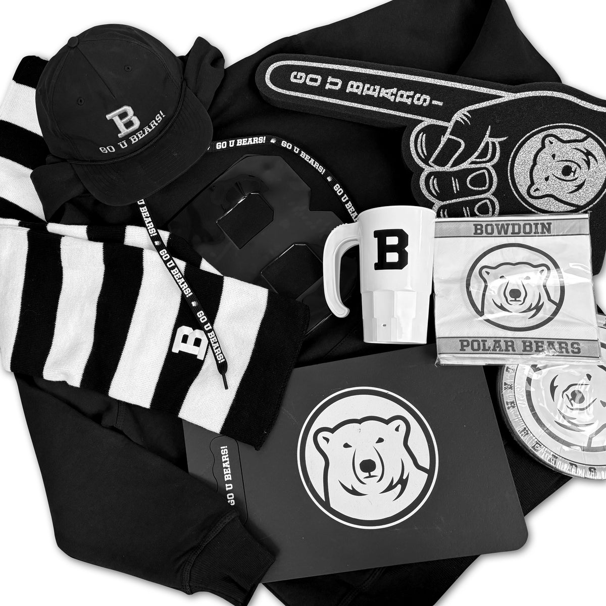 Collection of Bowdoin merchandise including a sweatshirt, scarf, hat, paper napkins, paper plates, plastic mug, and foam finger.