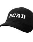 Black baseball cap with BCAD embroidered on the front in white.