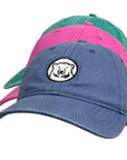 Blue, pink, and green hats with bear medallion.