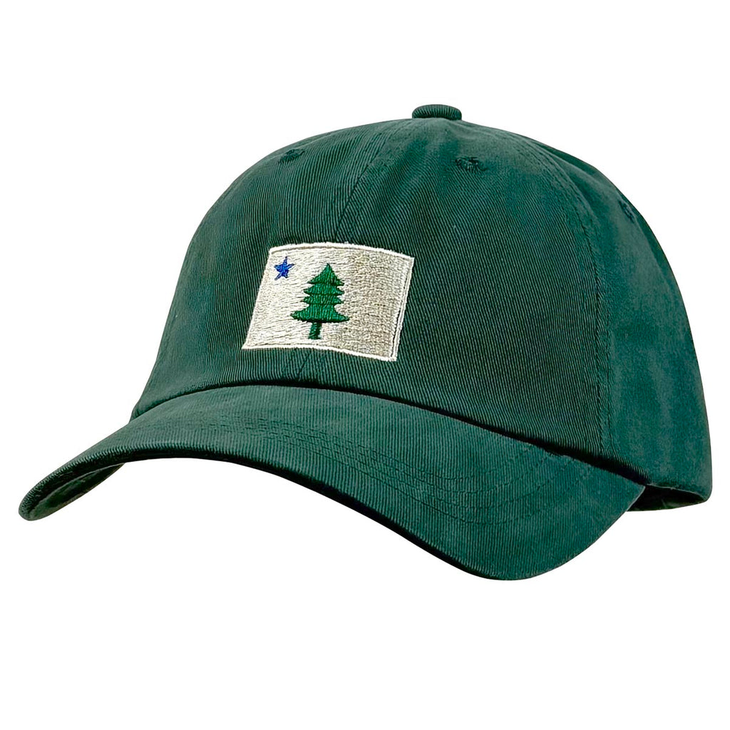 Dark green ball cap with buff embroidered rectangle with pine tree and blue star design. 