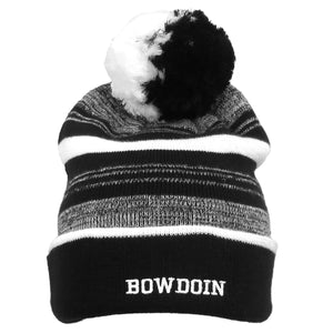 Cuffed knit beanie with stripes of varying widths in black, white, and marled black and white. Half-black, half-white pom. Embroidered white BOWDOIN on cuff.