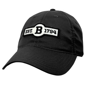 Dark grey ballcap with front patch in ivory felt with black embroidery of EST. B 1794.