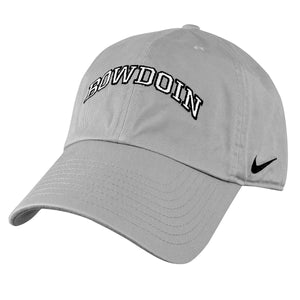 Light wolf grey ball cap with embroidered arched BOWDOIN on front in white with black outline. Black Nike swoosh embroidered on left temple.