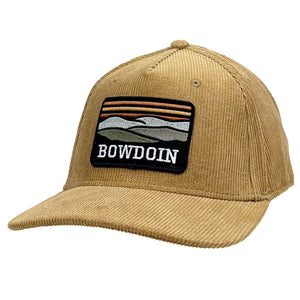 Tan corduroy trucker hat with large rectangular patch of tonal landscape hills and the word BOWDOIN beneath.