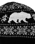 Knitted hat with black and white pattern featuring a bear and geometric shapes.