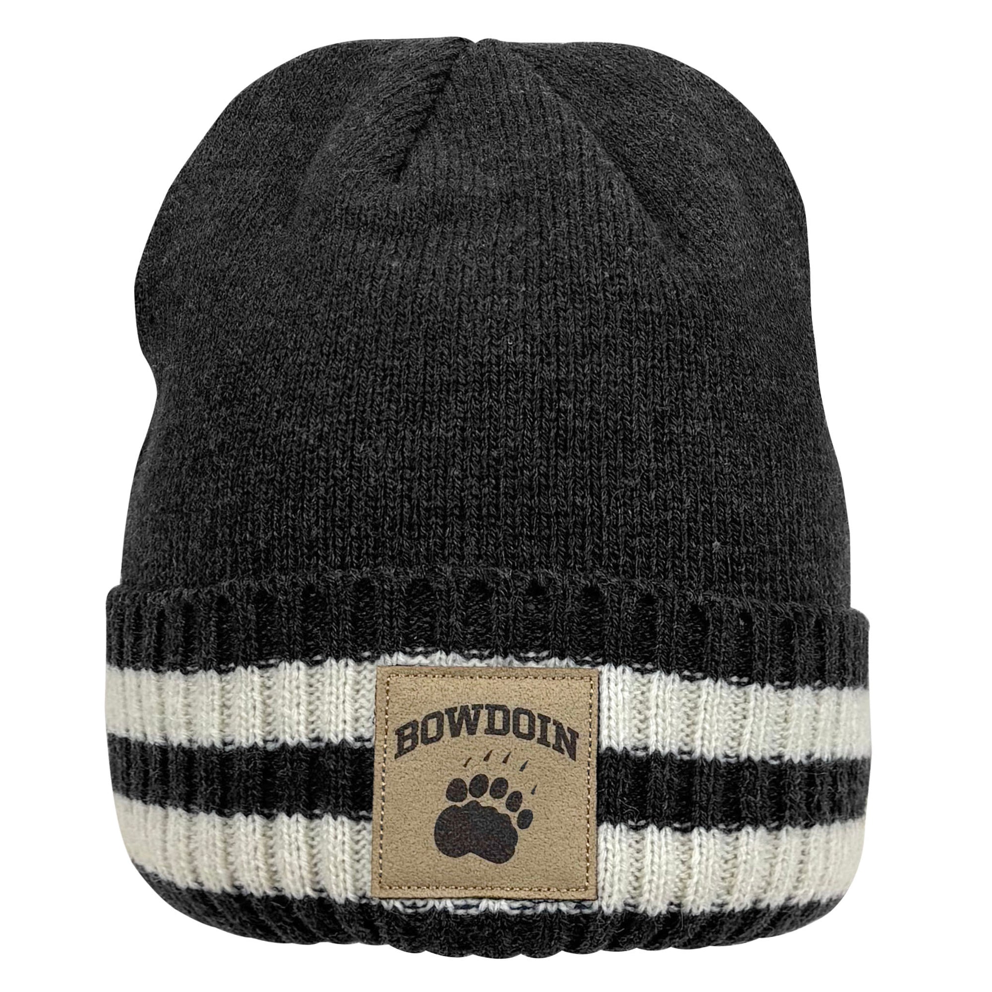 A dark charcoal gray knit beanie hat with a folded cuff featuring horizontal black and off-white stripes, and a tan rectangular patch with the text 'BOWDOIN' and a paw print.