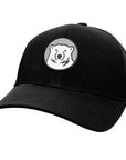 A black baseball cap with a circular patch on the front featuring a stylized white polar bear head on a gray background.