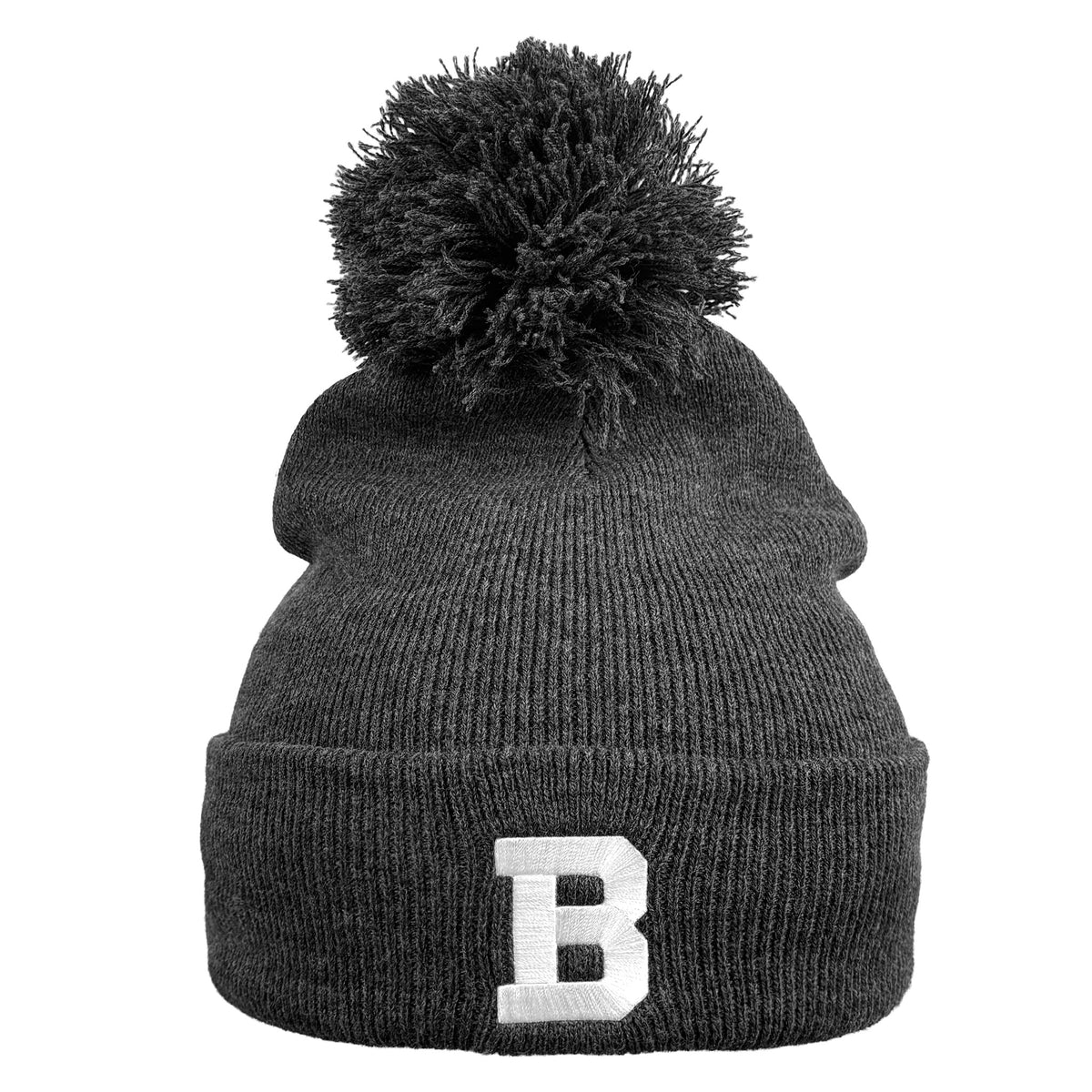 A dark gray ribbed knit pom-pom beanie with a white embroidered letter 'B' on the front cuff, shown against a plain white background.