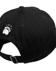 Black baseball cap with a white embroidered bear paw print on the side, shown from a rear three-quarter angle against a white background.
