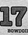 Close-up of a light gray heathered fabric with large dark gray embroidered numbers '179' and the word 'BOWDOIN' in black lettering below.