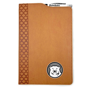 Brown leatherette journal with mascot medallion imprint on lower left corner. Cutout in cover on top shows a retractable Bowdoin-imprinted pen in an elastic pen loop.